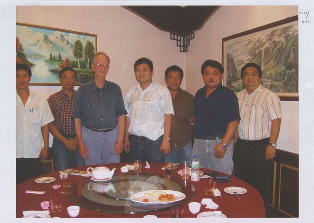 Miniature of Image of seven men standing in front of at table in a restaurant